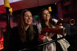 Two women on Kingdom Quest ride at adult night