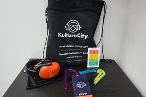 Kulture City bag showcasing items such as headphones, fidgets, and nonverbal emotions card